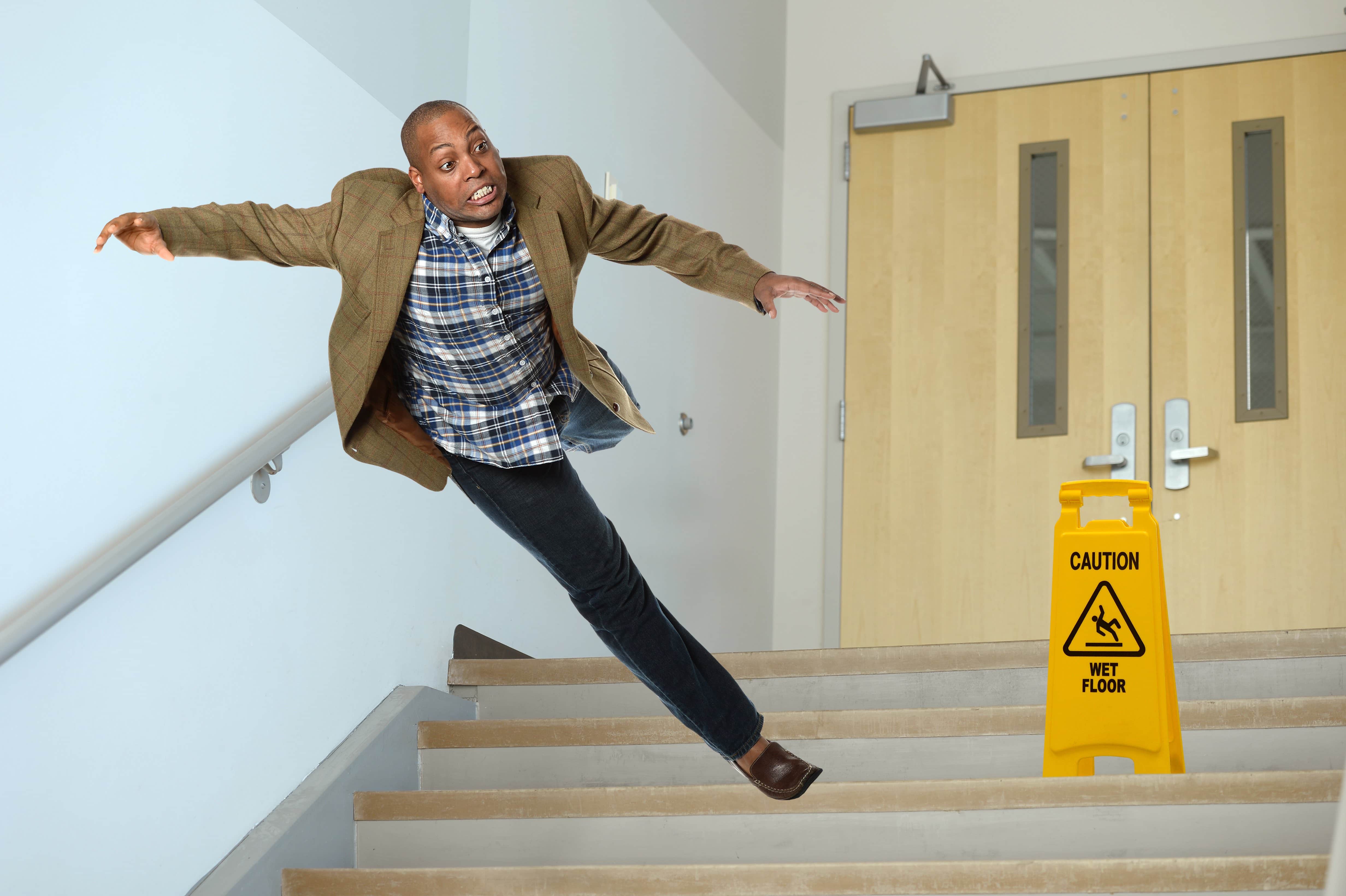 Man slipping down stairs.Stock Image - Gillan and Veldhuizen Inc
